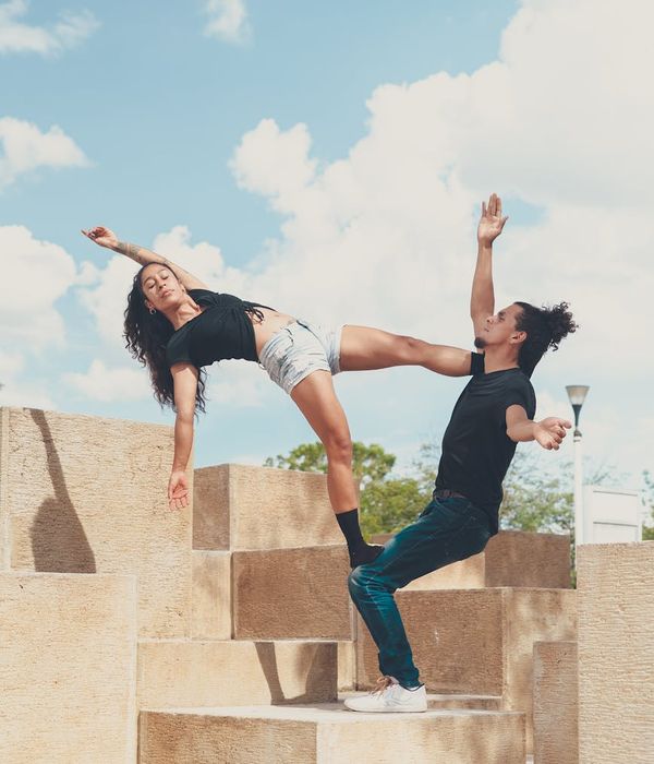 Woman performing a dynamic yoga stretch, looking energetic and focused.